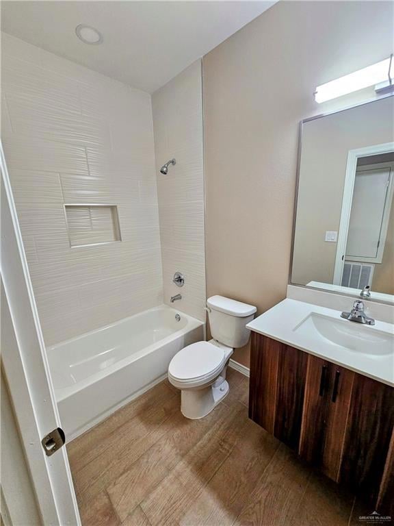Bathroom featuring vanity,  shower combination, wood finished floors, and toilet