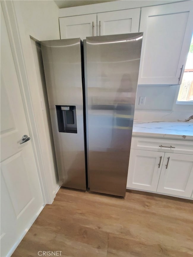 Sansung stainless steel refrigerator with icemaker.