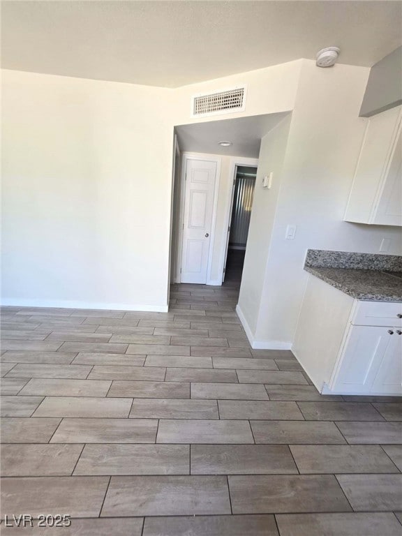 Unfurnished room featuring wood finish floors and