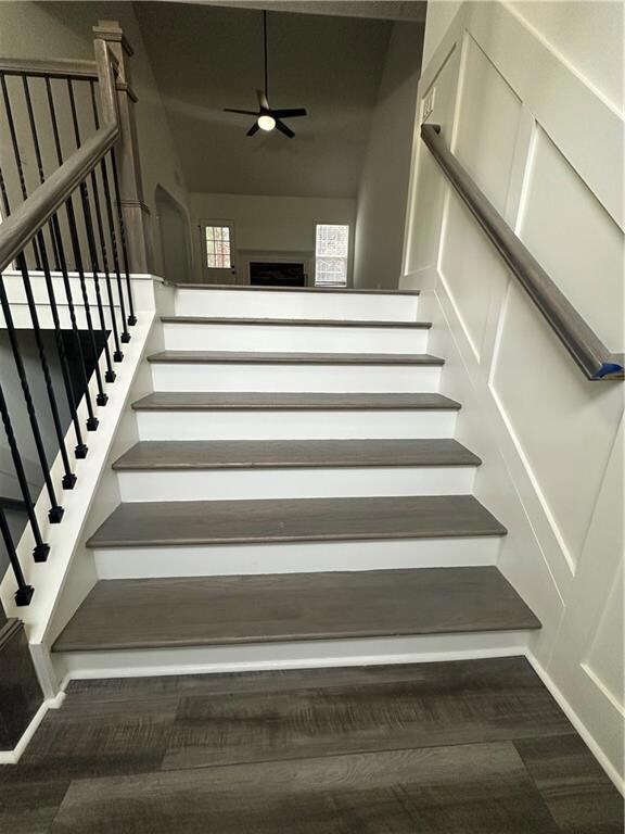 Staircase featuring ceiling fan