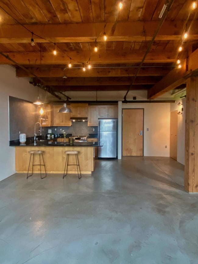 Large kitchen with ample storage and generous peninsula with room for at least four stools. the smooth concrete floors have in-floor heat paid for by the HOA.