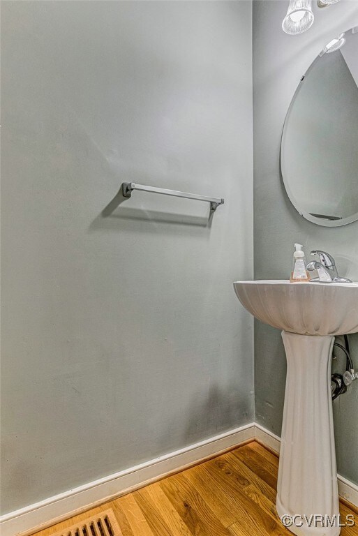 Bathroom with hardwood / wood-style flooring