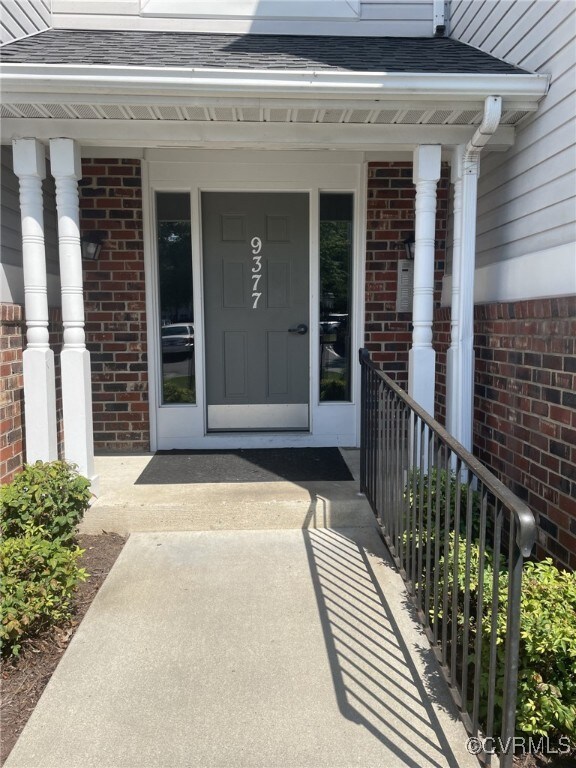View of exterior entry featuring a porch