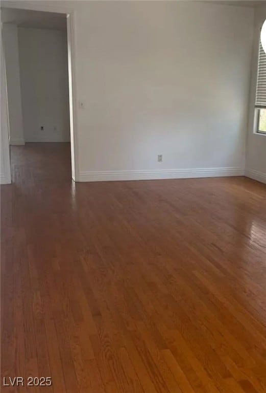 Spare room featuring wood finished floors