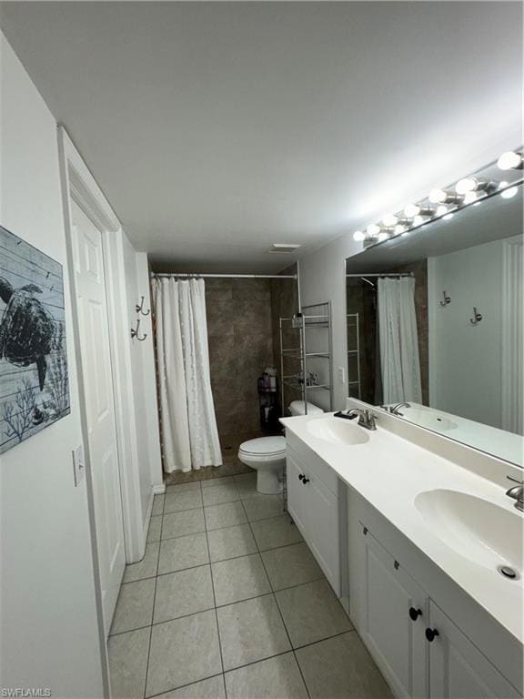 Bathroom with double vanity, a sink, and tile patt