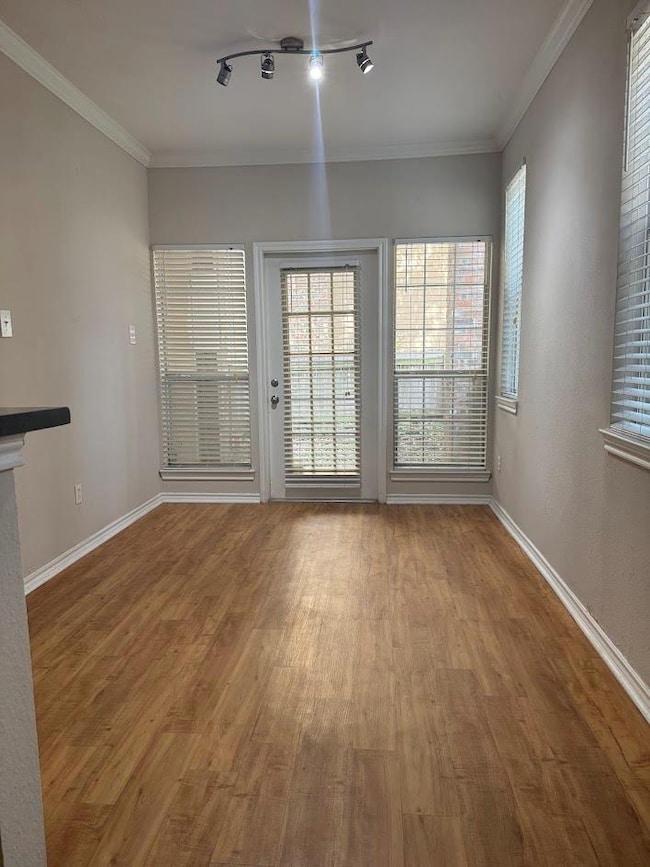 Unfurnished living room featuring wood finished f