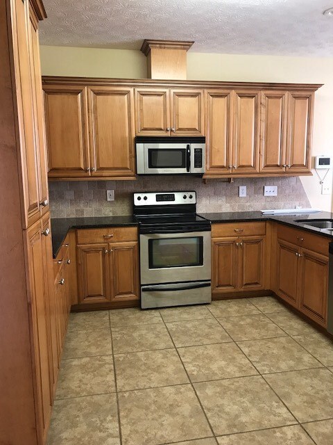 Granite countertops and stainless appliances; tile