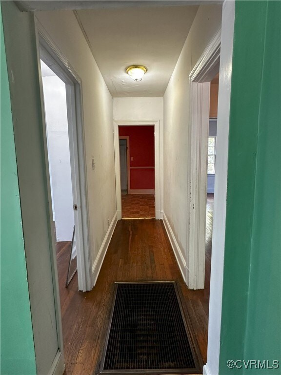Corridor featuring dark hardwood / wood-style floo