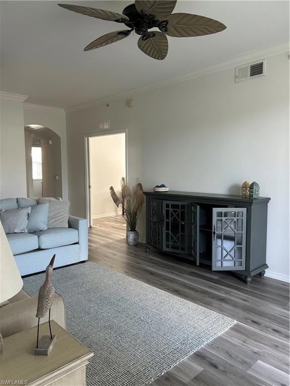 Living room featuring ceiling fan, hardwood / wood