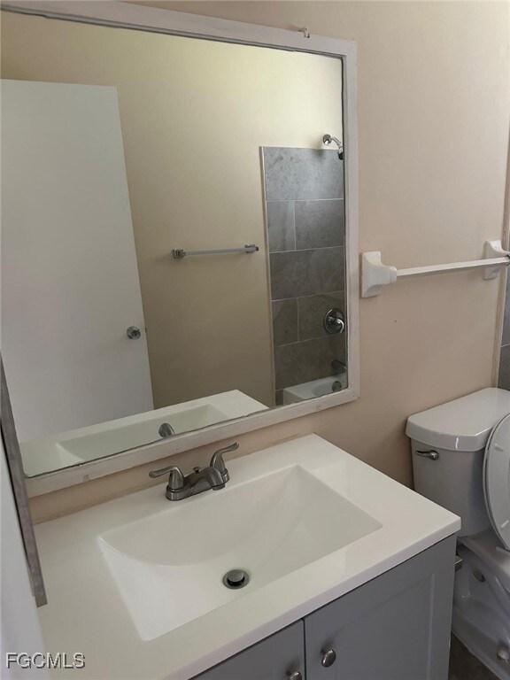 Bathroom with vanity and shower / tub combination