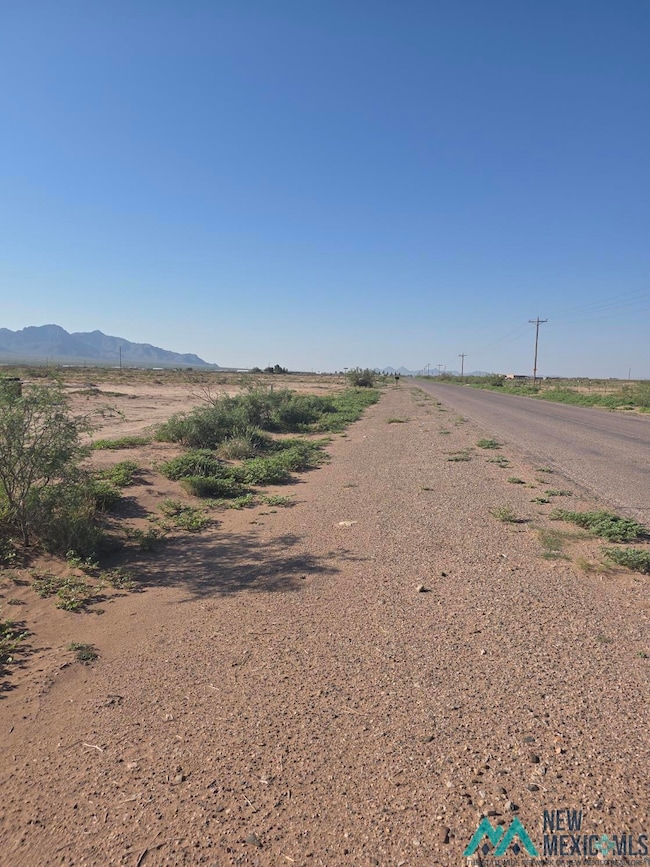View of asphalt road featuring a view of rural / pastoral area