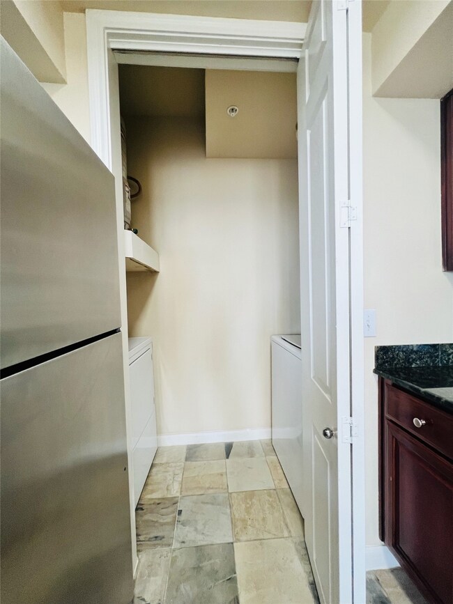 The full size washer and dryer are tucked away in a closet in the kitchen area