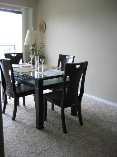 Dining space with carpet flooring and baseboards