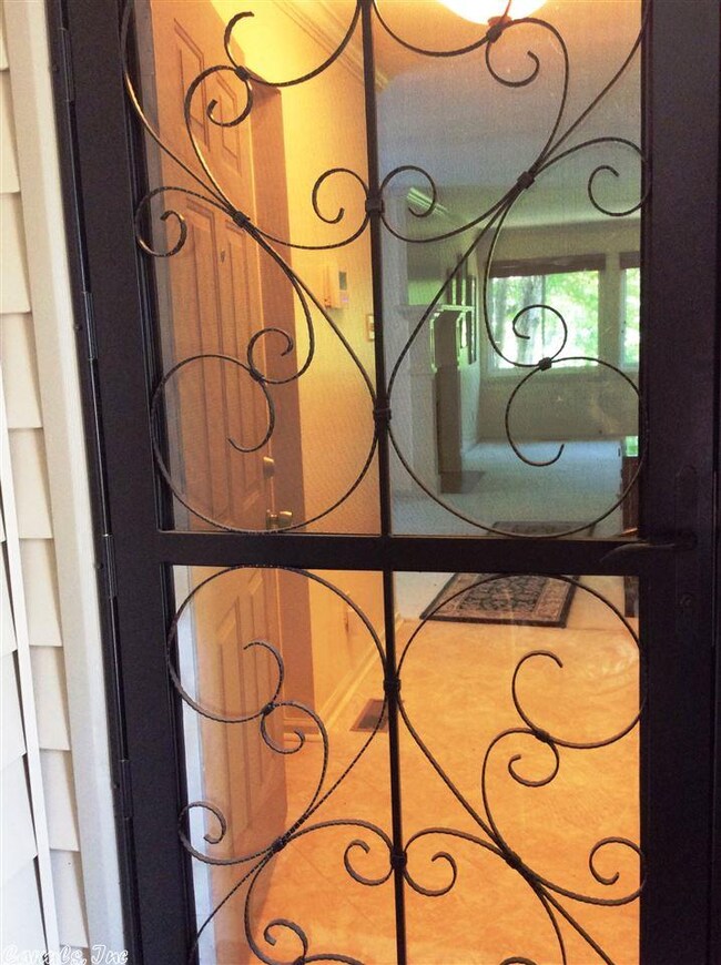 Glass Storm Door behind wood door opens to entry