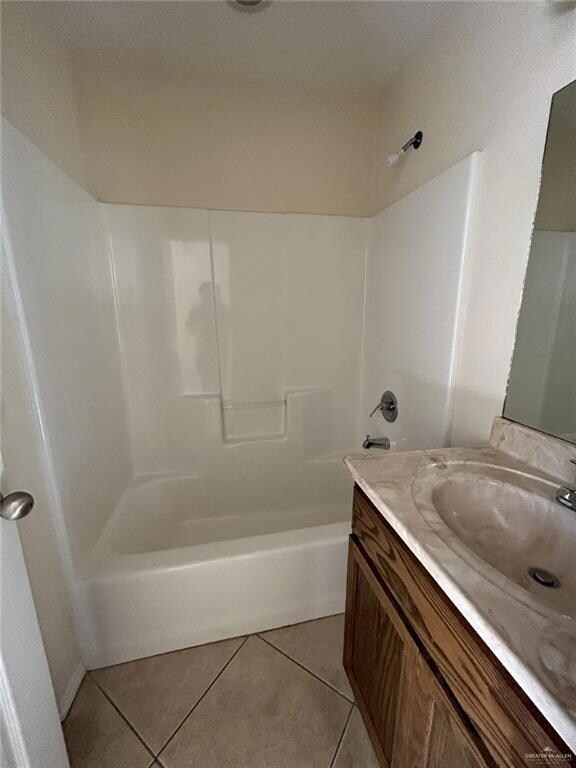 Full bath with tile patterned floors, vanity, and shower / bathtub combination