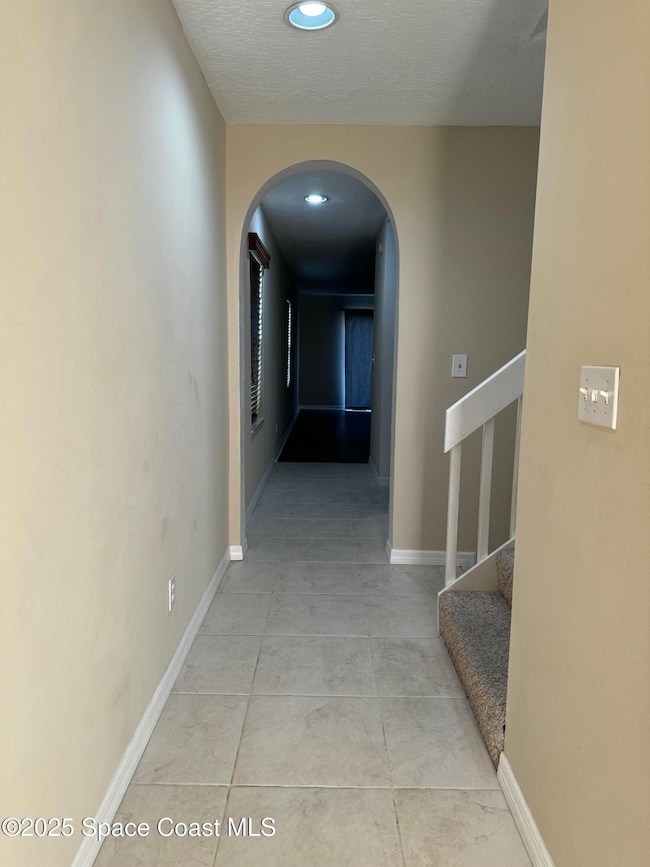 Hall leading to stairs and living area