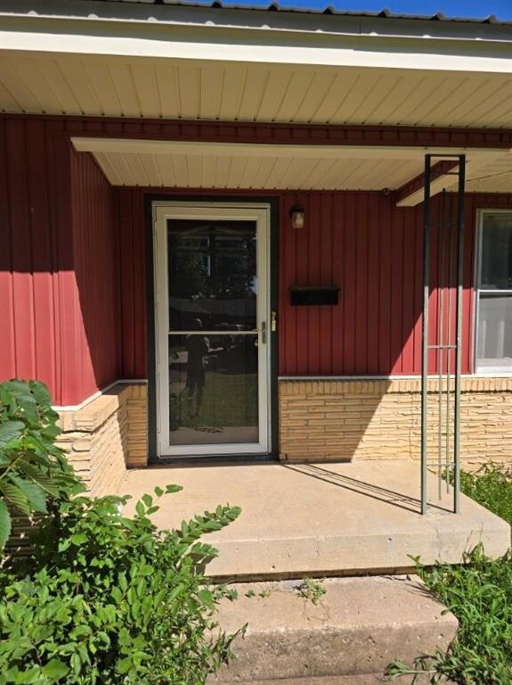 Entrance to property with brick siding