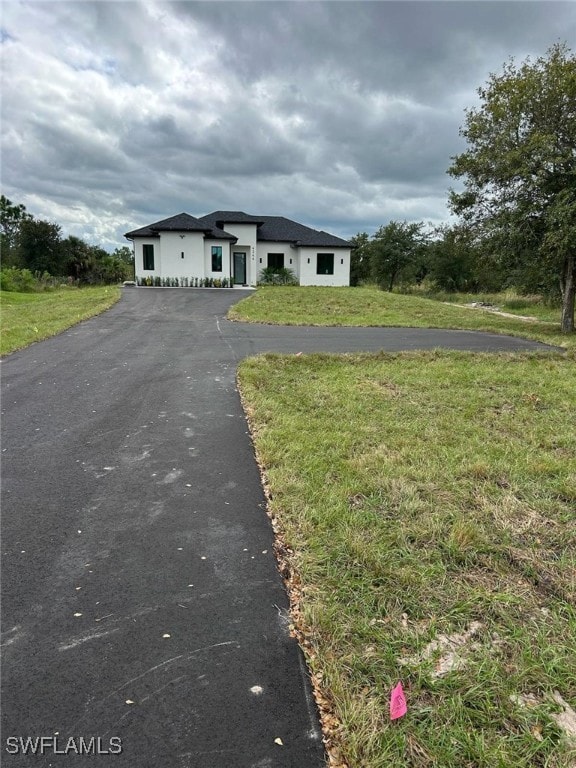Prairie-style house featuring a front yard and driveway