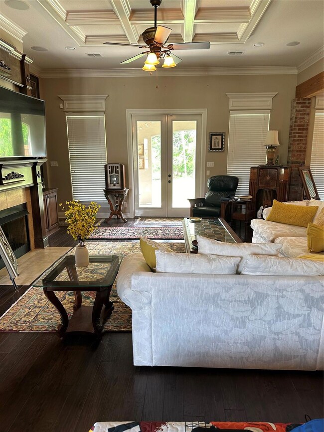 Living room with beam ceiling, crown molding, ceil