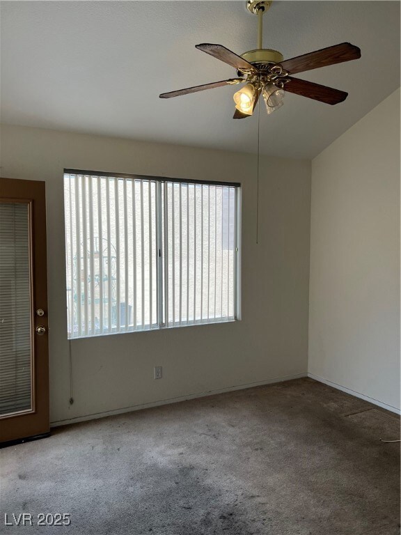 Carpeted living room with ceiling fan and a wealth