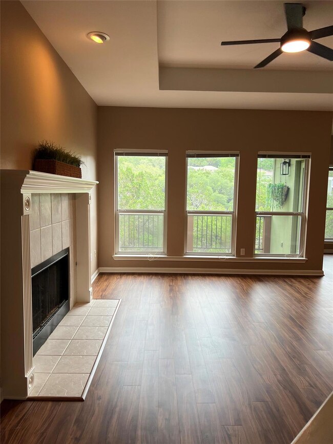 Unfurnished living room featuring a ceiling fan, 