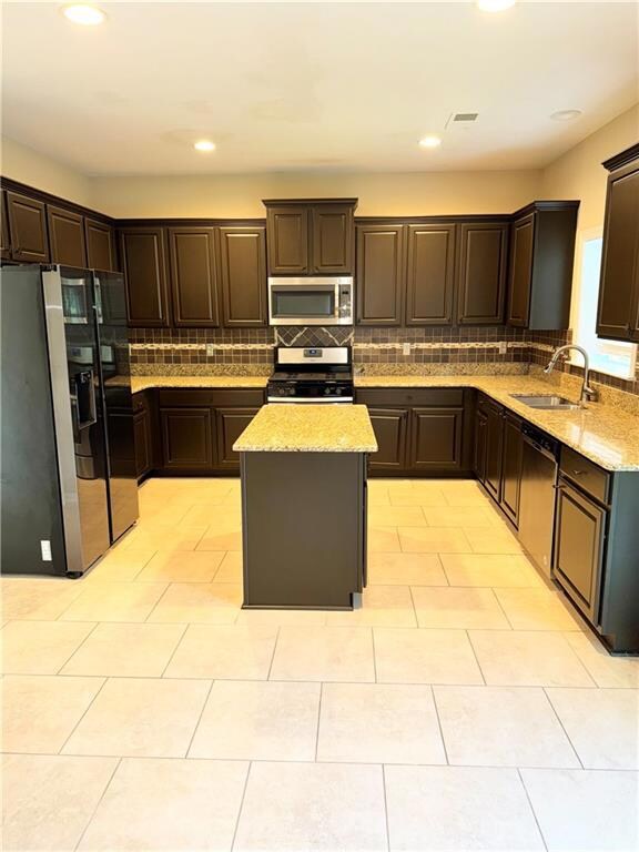 Kitchen featuring stainless steel appliances, a si