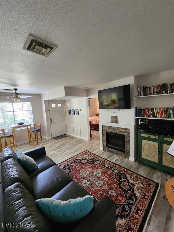 Living area featuring wood finished floors, a text