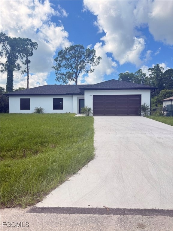 Ranch-style house featuring stucco siding, a garage, concrete driveway, a front yard, and a shingled roof