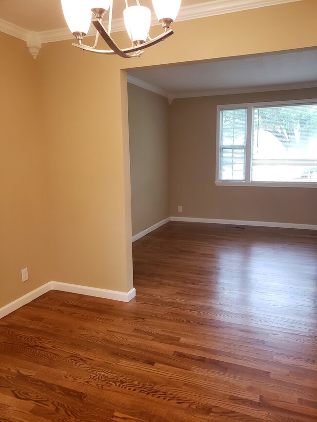 A view from the large kitchen area into the great room.  Home has large window for great vistas to large treed lot.  NEWER WINDOWS.
