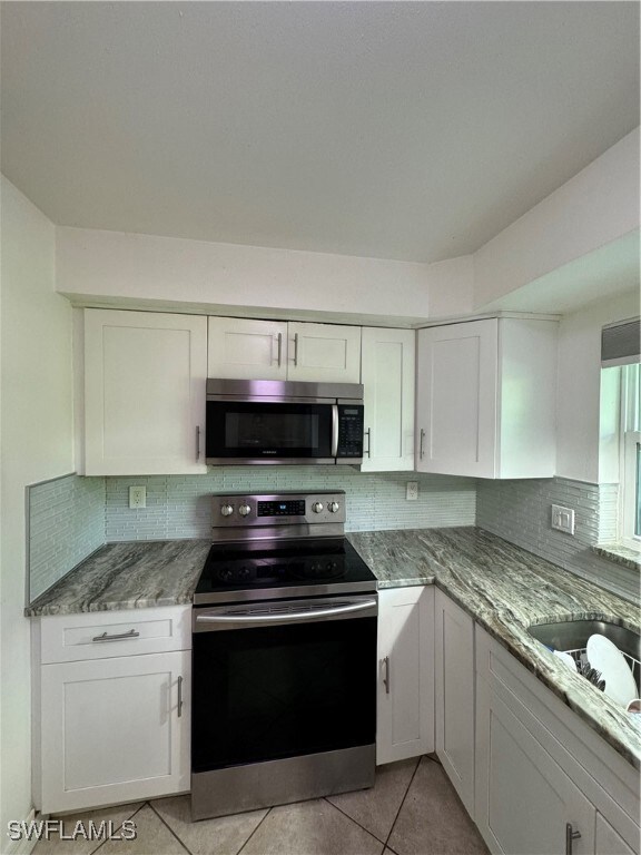 Kitchen featuring stainless steel appliances, ligh