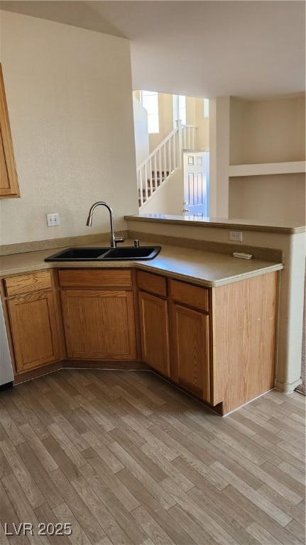 Kitchen featuring a sink, light wood-style floorin