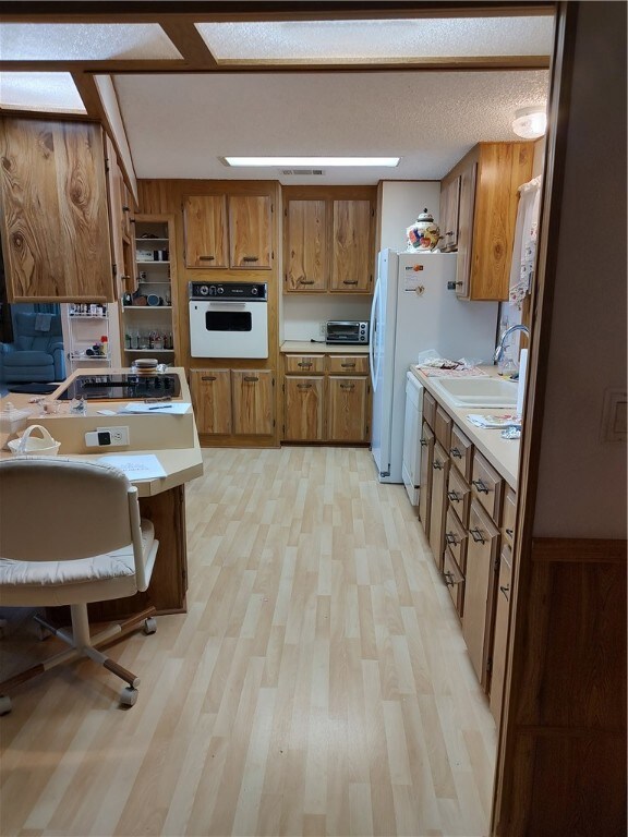 Kitchen features cooktop and wall oven
