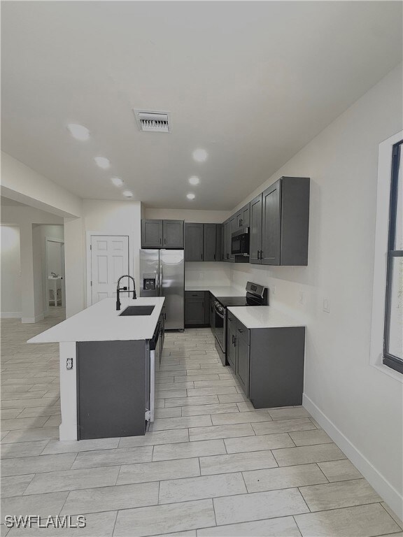 Kitchen with stainless steel appliances, a sink, w