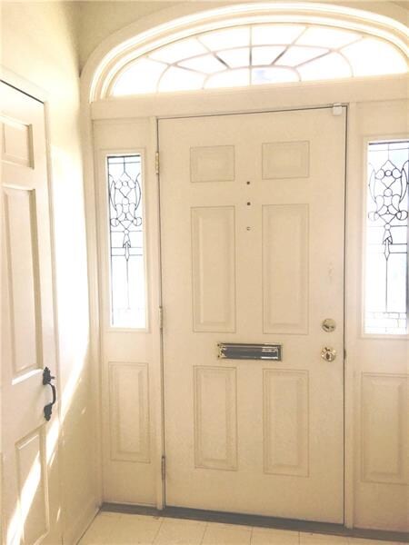 Bright white foyer welcomes you with two coat clos