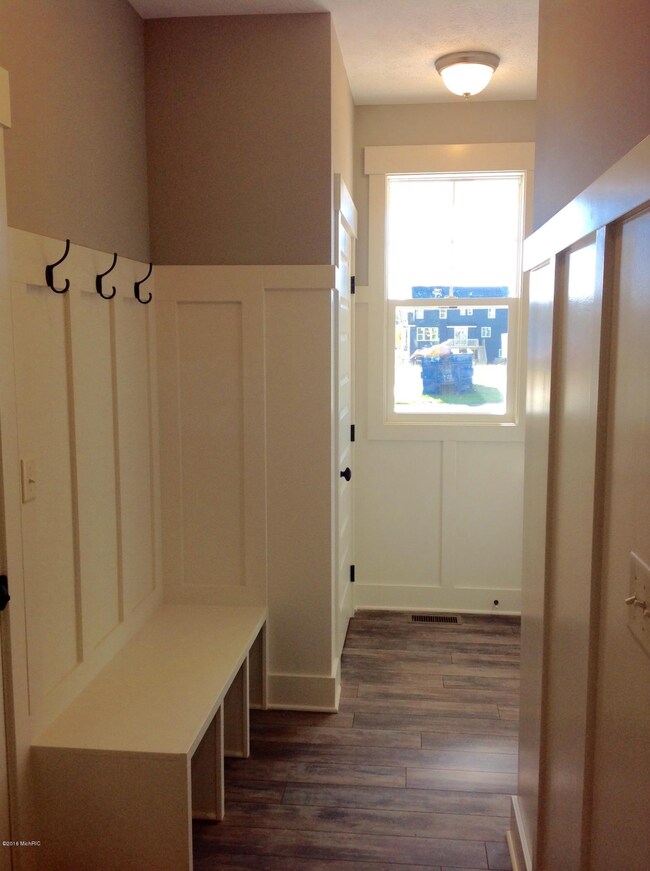 Mudroom with bench and coat closet