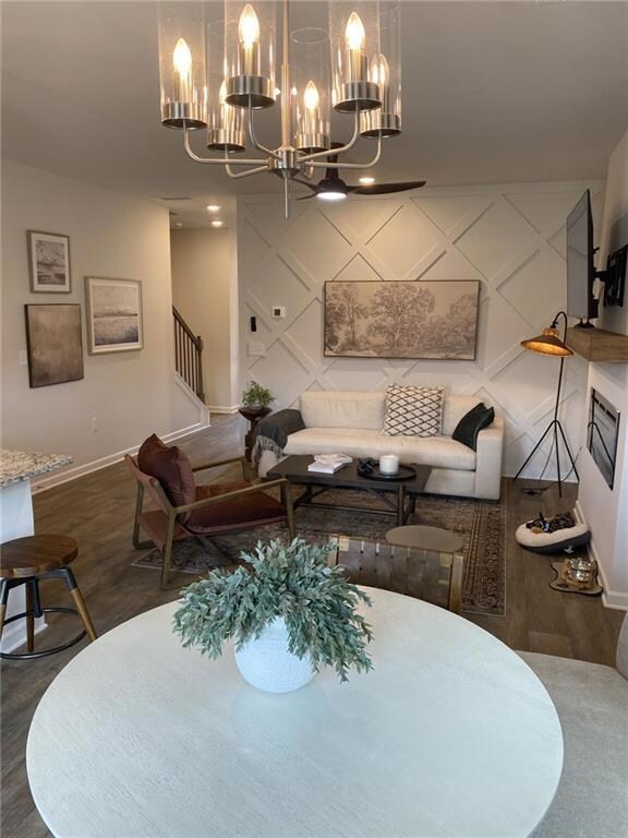 Dining room featuring dark wood-style floors, a chandelier, and recessed lighting