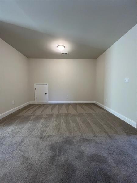 Unfurnished room with baseboards and carpet flooring