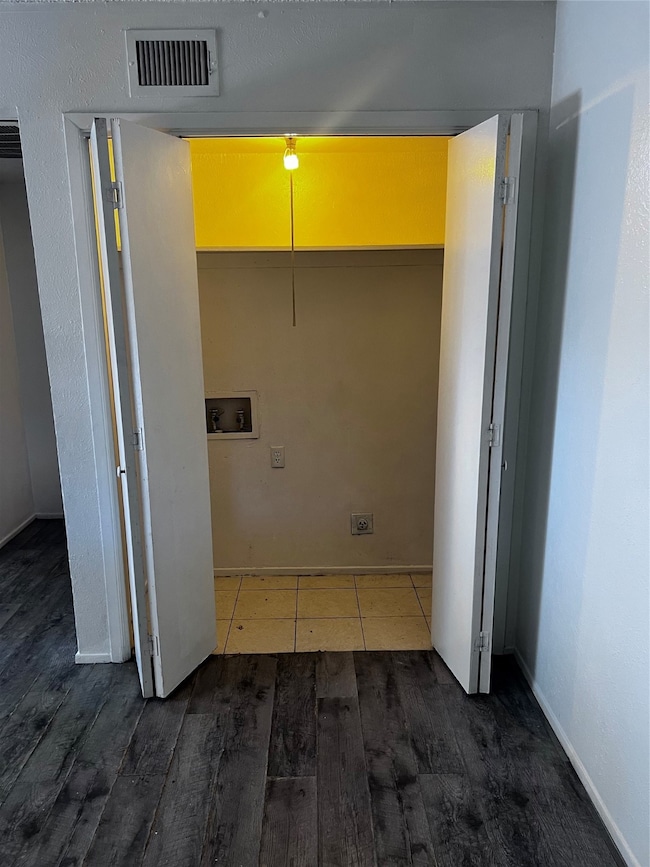 Laundry area featuring wood finished floors and hookup for a washing machine
