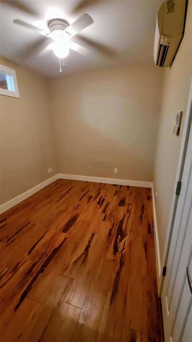 Unfurnished room featuring wood finished floors, 
