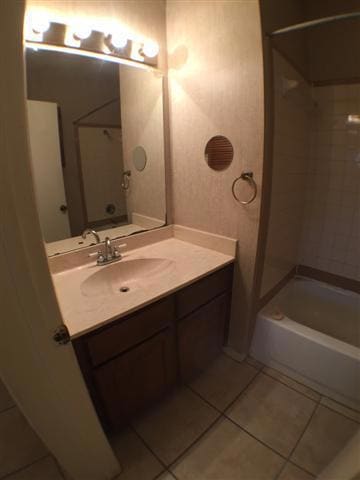 Bathroom with tile patterned flooring, vanity, an
