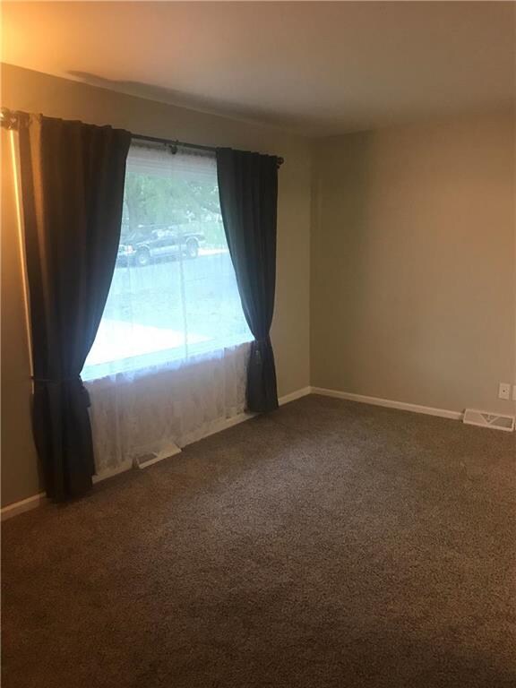 Living Room with new carpet and Interior Paint.