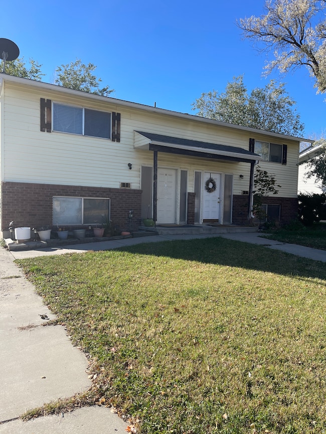 View of front of property with brick siding and a front yard