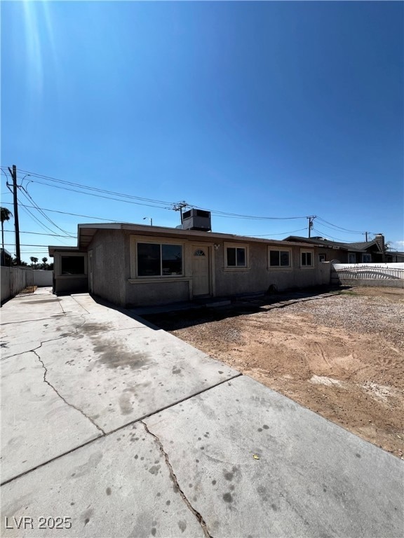 Ranch-style home with a chimney and driveway