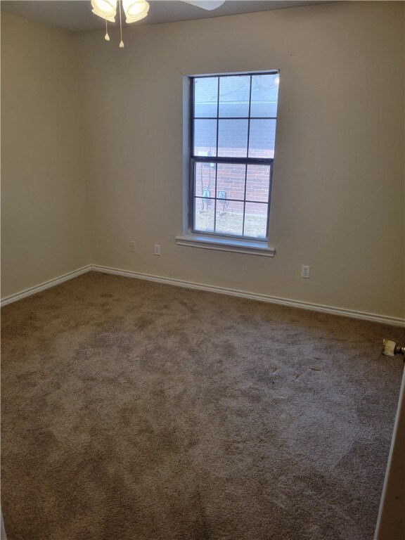 Unfurnished room with carpet floors and baseboards