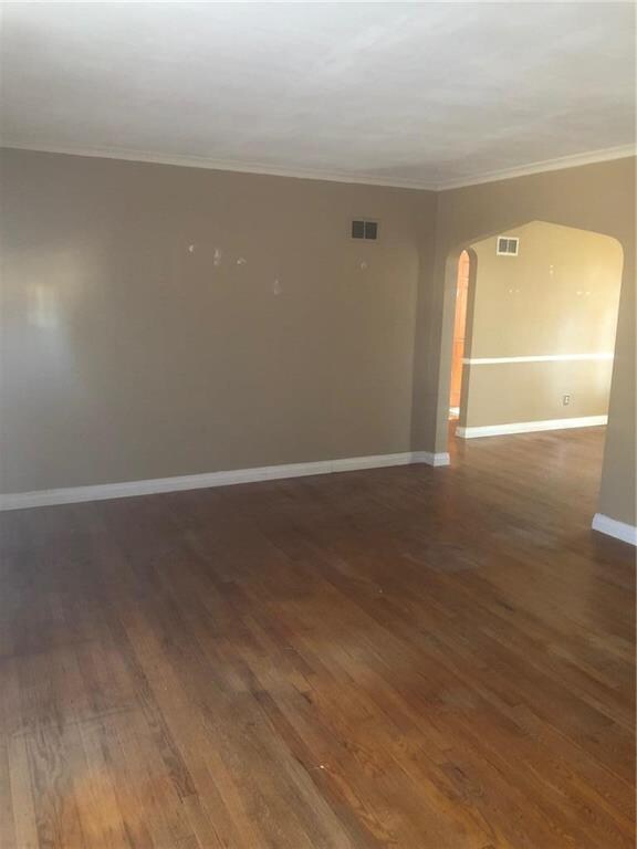 Arched doorway in living room leading into dining 