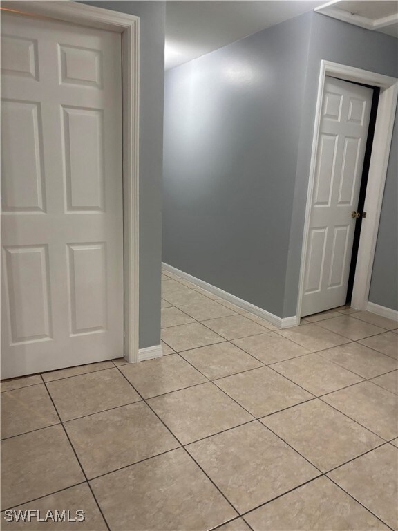 Empty room featuring light tile patterned floors a