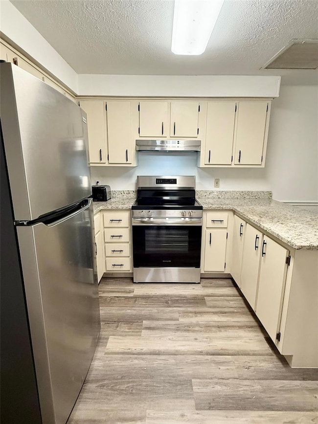 Kitchen features brand new stainless steel appliances,  granite countertops and breakfast bar