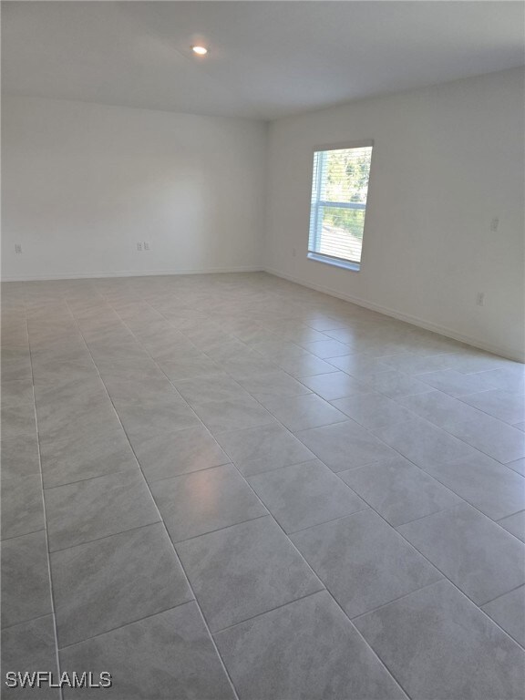 Spare room featuring light tile patterned floors,