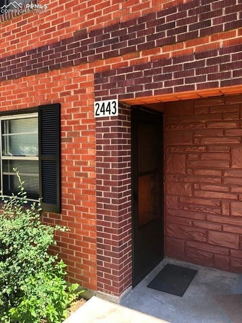 Entrance to property with brick siding
