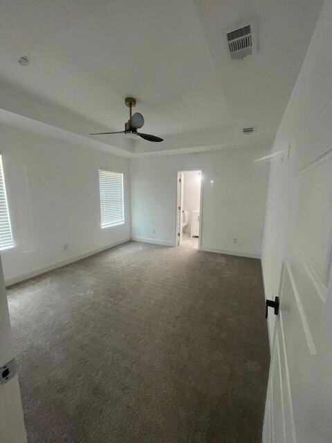 Carpeted empty room featuring ceiling fan